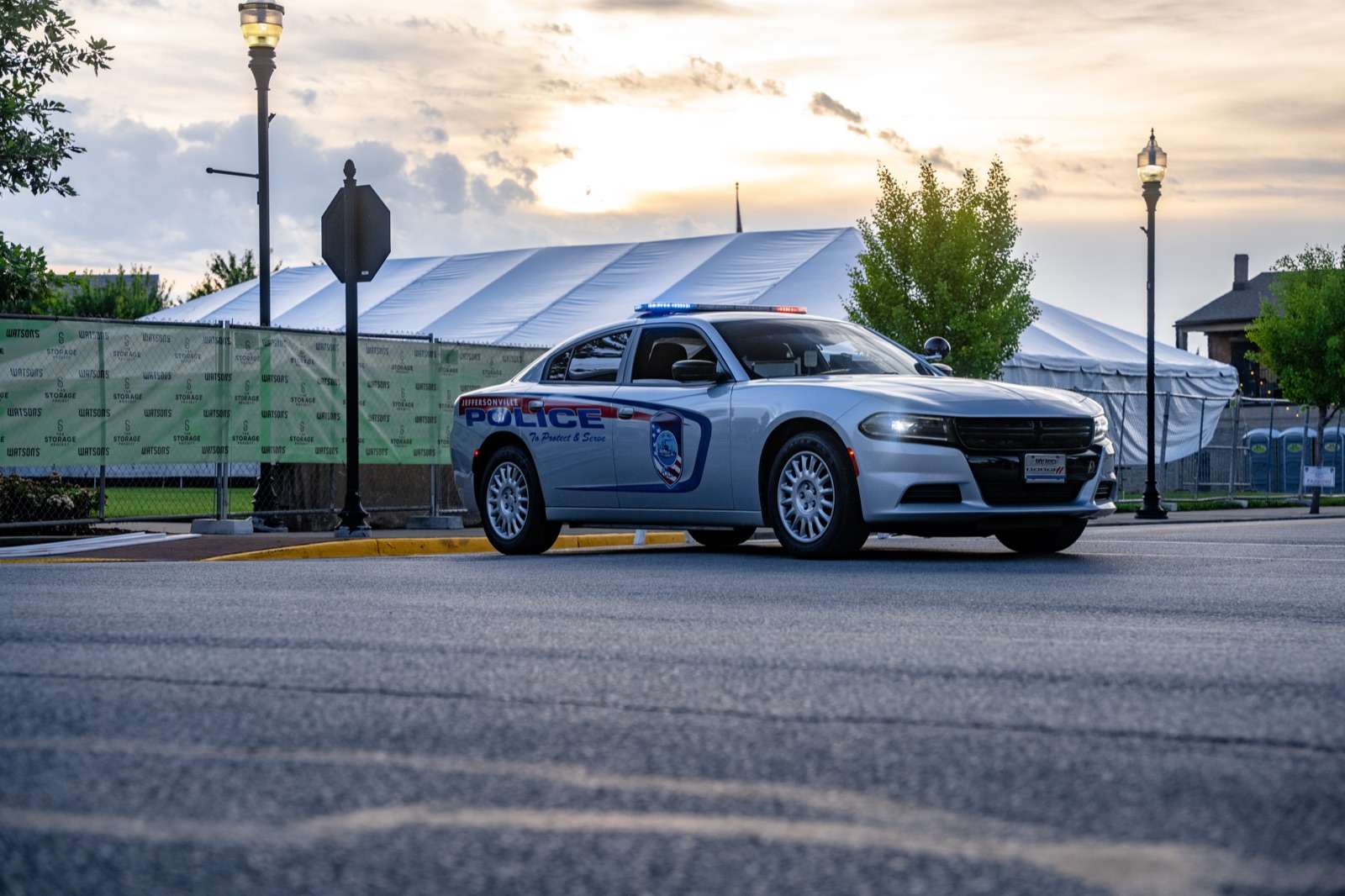 Jeffersonville Police cruiser at sunset with emergency lights on during a festival detail