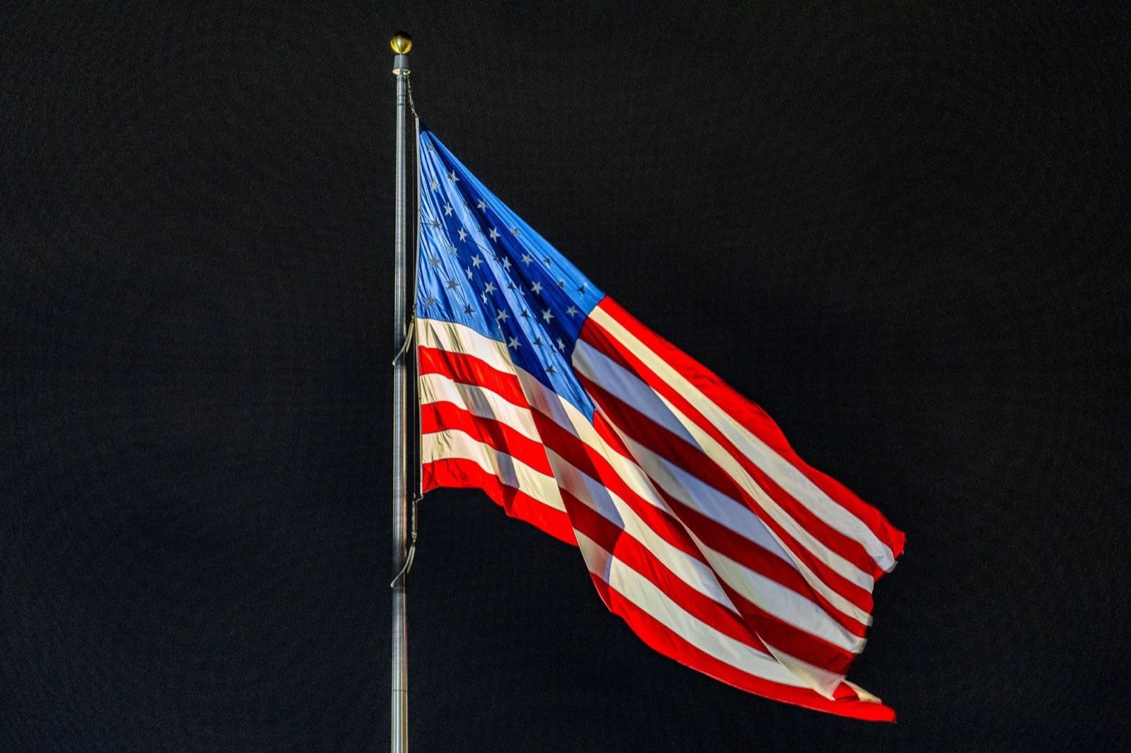 American flag flying at night